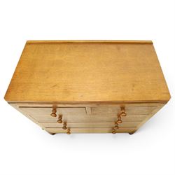 Mouseman - early-to-mid 20th century adzed and panelled oak chest, raised back over rectangular adzed top with canted corners, fitted with two short over three long drawers with turned knob handles, raised on octagonal feet, with carved mouse signature, by the workshop of Robert Thompson of Kilburn
