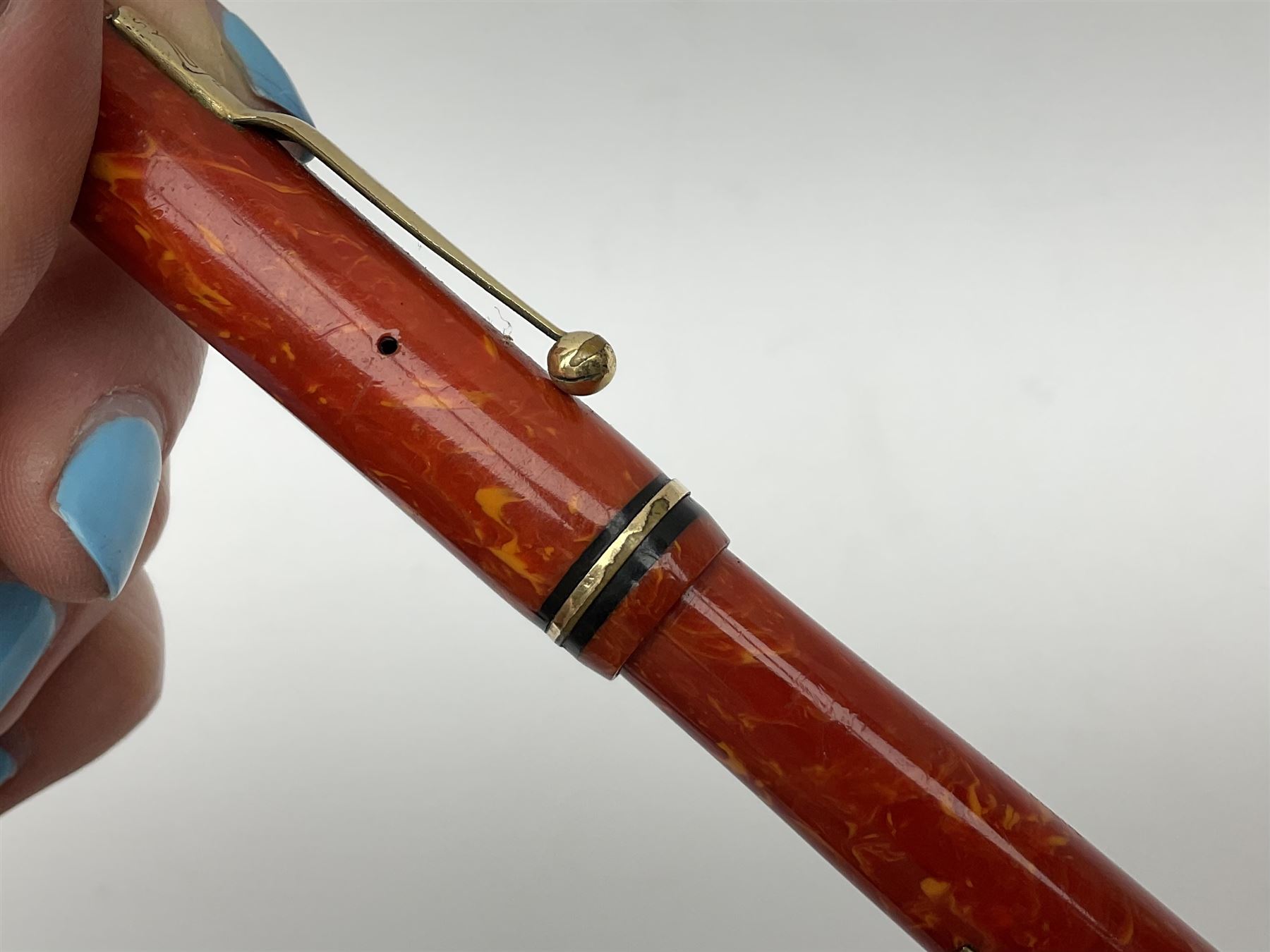 Vintage Swan Mabie Todd lever fill fountain pen in coral red, the nib a/f marked 14K, together with two further vintage Swan Mabie Todd fountain pens, the first example with lever fill, the other leverless, each with black body, one with nib marked 14ct, (3) 