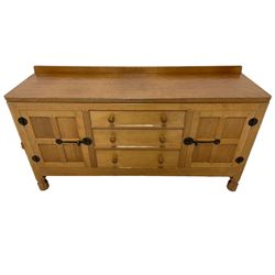 Mouseman - oak dresser, rectangular adzed top with raised back over three central drawers and two flanking cupboards, enclosed by panelled doors with wrought metal fixtures, the canted upright carved with mouse signature, on octagonal feet, by the workshop of Robert Thompson, Kilburn