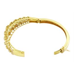 18ct gold diamond heart bangle, two rows of eleven graduating heart motifs, each set with pave set diamonds, spaced by ten round brilliant cut diamonds, total diamond weight approx 1.90 carat