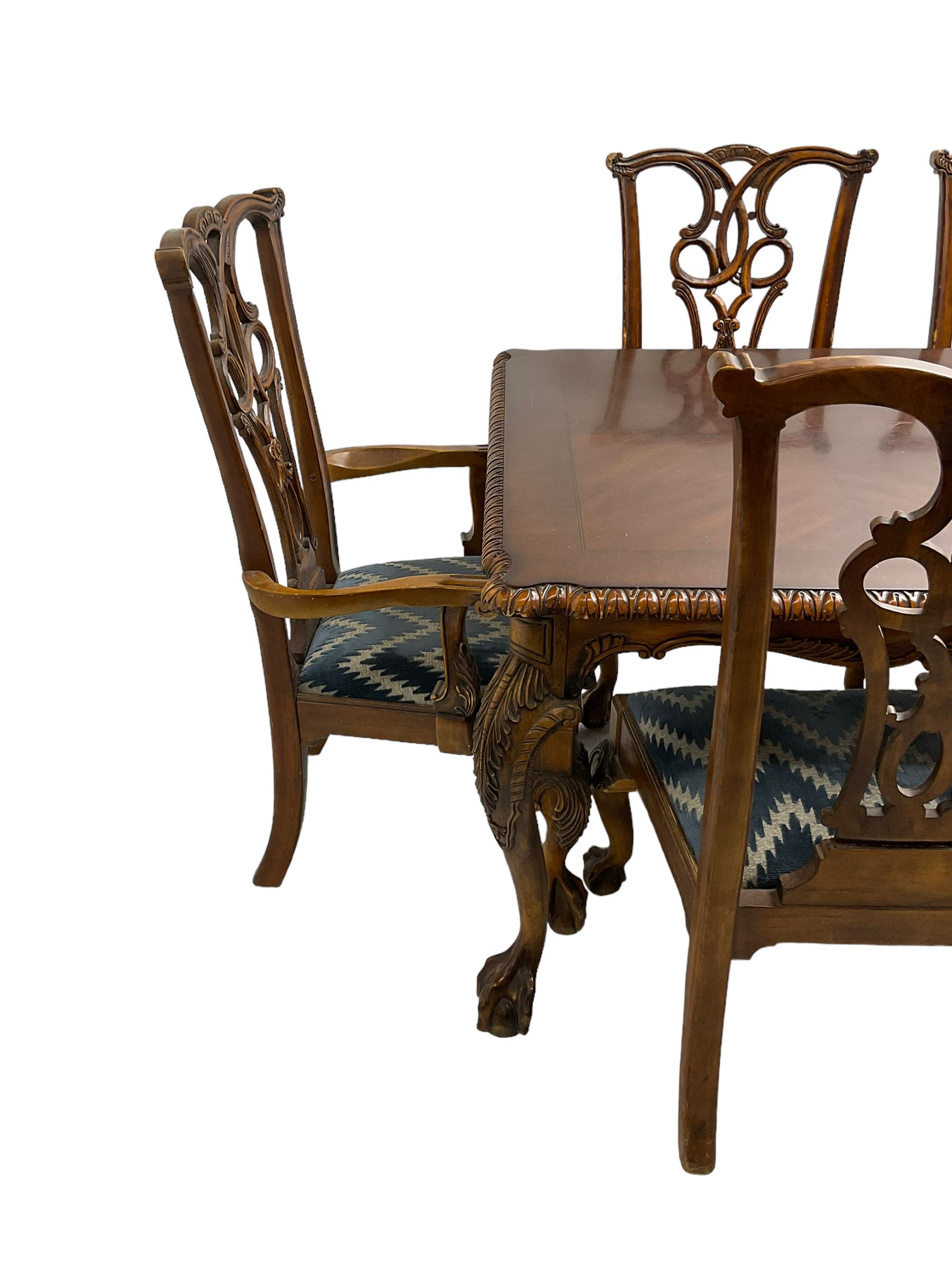 Chippendale Revival - hardwood extending dining table, rectangular gadroon carved top, on acanthus carved cabriole supports with ball and claw feet, with two additional leaves; together with a set of eight (6+2) dining chairs, shaped cresting rail over pierced and carved splat, upholstered drop-in seat, on acanthus carved cabriole supports with ball and claw feet