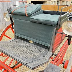 Holland & Holland Tandem Cart - Althorp Spencer Family Estate

A two wheeled tandem cart or cocking cart by Holland & Holland Coach Builders, London, with black painted bodywork, red painted shafts and running gear, red wooden spoked wheels with rubber tyres, green upholstered seating and a rear perforated metal footboard. The cart is fitted with carriage lamp brackets (lamps next lot), green buttoned cushions with leather retaining straps, side louvered body panels, footrests, leaf spring suspension and shafts for horse use. The carriage incorporates an adjustable body position, operated by a lever, allowing the body to be moved forwards or backwards to alter the weight distribution. Formerly owned by the family of Lady Diana Spencer,
Sympathetically conserved by Woods of Fairbourne Carriages Ltd, Kent.

Features:
• Brass maker’s plaque for Holland & Holland Coach Builders, London
• Two wheeled tandem cart
• Black painted body with red painted shafts and running gear
• Red wooden spoked wheels with rubber tyres
• Green upholstered cushions with leather retaining straps
• Adjustable carriage body for weight distribution
• Lever operated adjustment mechanism
• Perforated rear footboard
• Side footrests
• Louvered side panels
• Leaf spring suspension
• Rear opening storage compartment
• Decorative painted armorial motif to rear panel
• Fitted carriage lamps shown, not included in the lot (available as next lot)
• Conserved by Fairbourne Carriages Ltd
• Provenance: The Althorp Attic Sale including The Spencer Carriages, lot 195, 7 July 2010

Dimensions:
Overall length 396 / 198cm
Width 155cm
Height 190cm

Wheel Diameters:
Wheels: 148cm

Seating:
Driving seats: 2
Passenger seats: 2