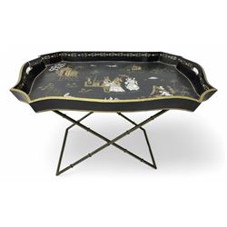 19th century design Chinoiserie style lacquered tray, painted with traditional scenes with figures and pagodas with gilt detail, on a folding simulated bamboo metal stand