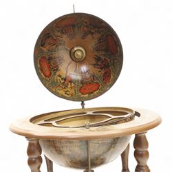 20th century Italian design drinks globe, the hinged celestial printed sphere enclosing a fitted bottle and glass compartment, circular base decorated with zodiac signs and mounted on turned supports with castors
