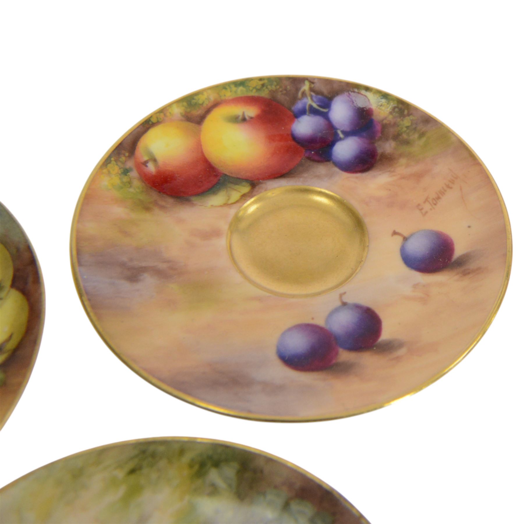 Two small 20th century Royal Worcester cabinet cups and saucers, together with another saucer, each painted with a still life of fruit upon a mossy ground, bearing various signatures: E Townsend, Ricketts, G H Cole, and H Ayrton, each with puce printed mark beneath, teacups approximately H3cm D5.5cm, coffee cup H4.5cm, saucers 9.5.cm