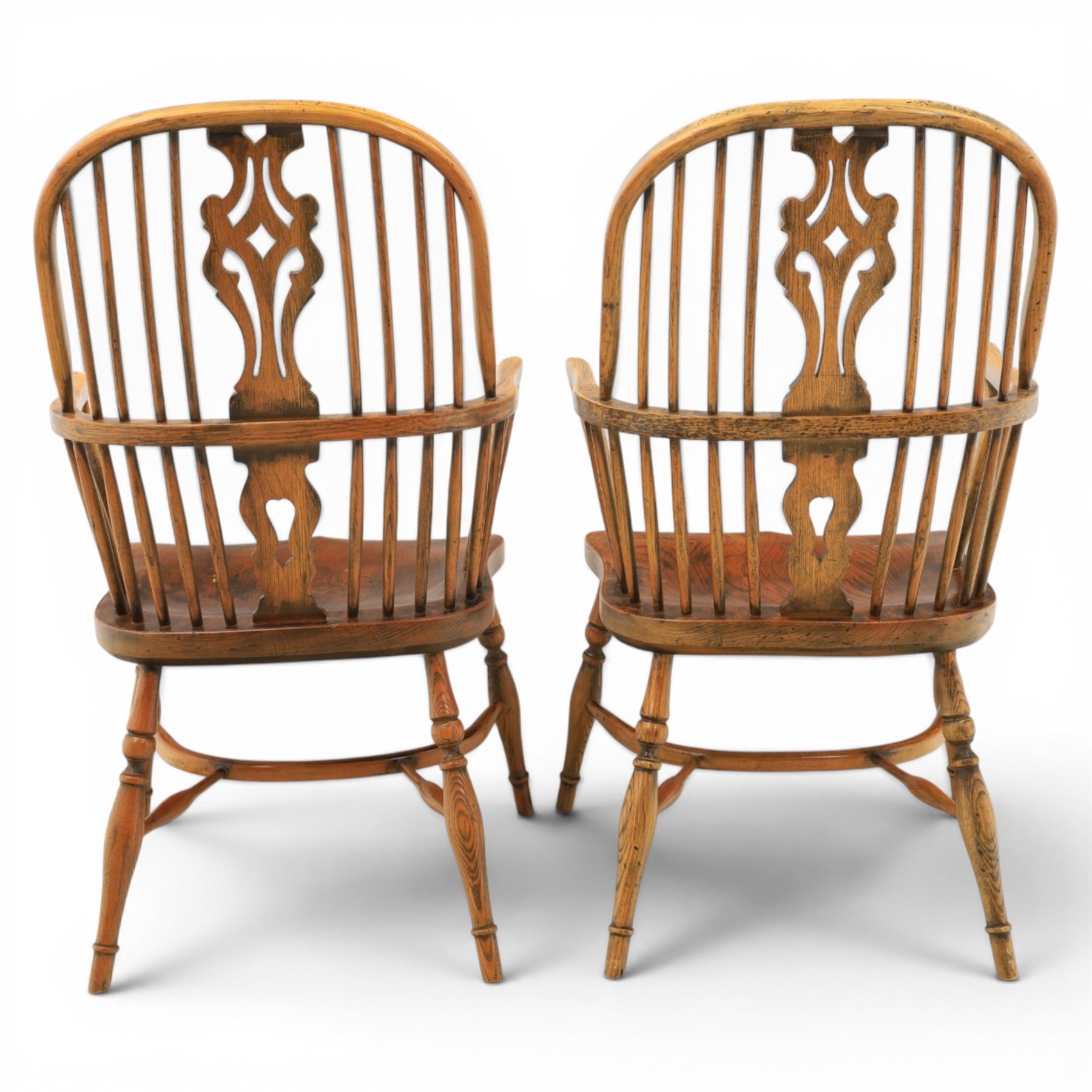 Pair of high back Windsor armchairs, fleur de lis back splat, dished seat, caroline stretcher