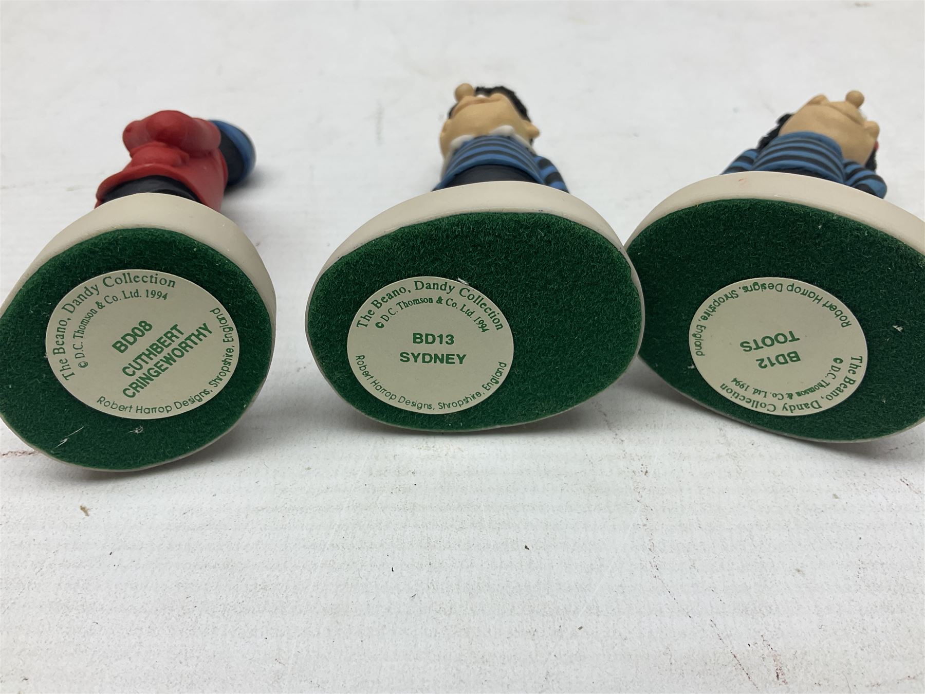 Thirteen Robert Harrop figures from the Beano Dandy collection, comprising Yo-Yo Collectors Piece 1996, Desperate Dan BD03, Cuthbert Cringeworthy BD08, Teach BD06, 'Erbert BD14, Toots BD12, Winston BD17, Fatty BD07, Dennis The Menace BD01, Dennis the Menace Fishing BD806, Sydney BD13, Wilfrid BD15 and Plug BD11