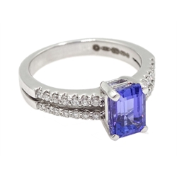  18ct white gold emerald cut tanzanite ring, the shank with two rows of round brilliant cut diamonds, hallmarked  