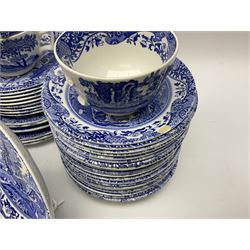 Spode blue and white Italian pattern dinner and tea wares, comprising five dinner plates, four side plates, seventeen side plates, four bowls, ten tea cups and twenty one saucers, five coffee cans and six saucers, and a flan dish, with blue and black printed marks beneath 