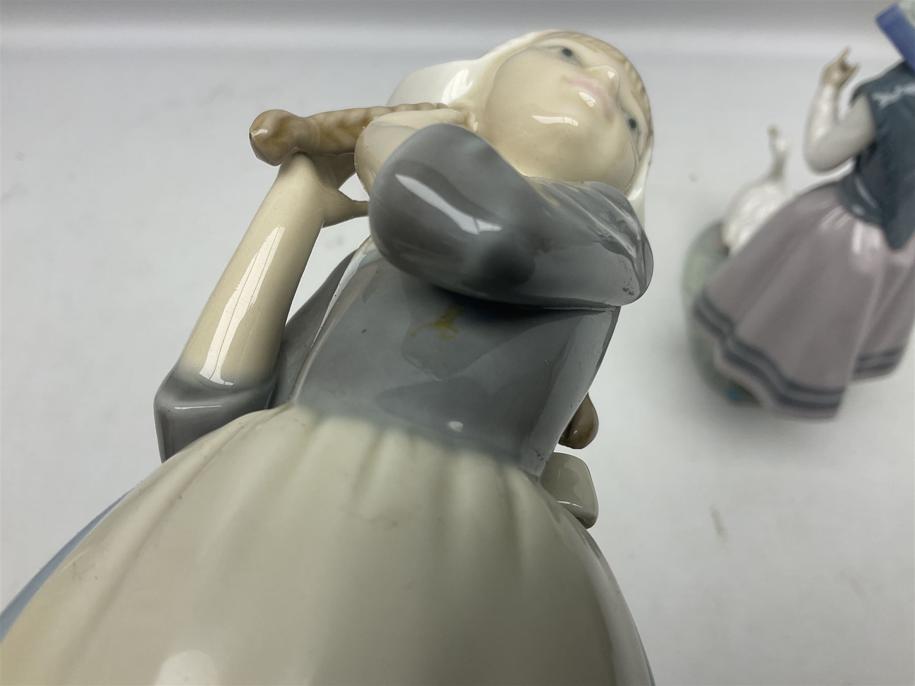 Three Lladro figures, comprising Dutch Girl with Braids no 5063, Dutch Girl with Duck no 5066 and Aracely with Ducks, all with original boxes, largest example H25cm