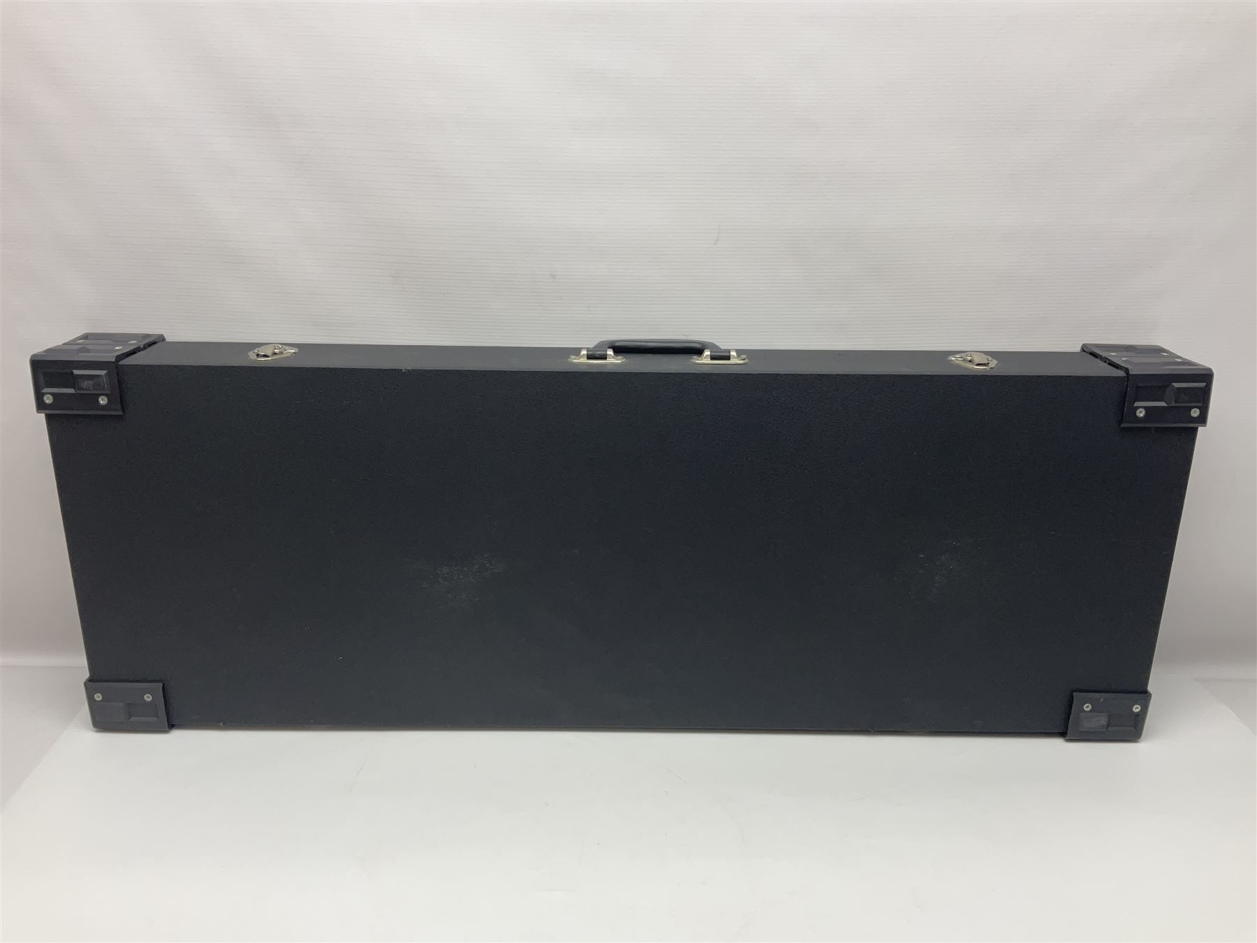 Copy of a Fender Stratocaster electric guitar in black with Wilkinson bridge, lock-in tuners, synchronised tremolo and various patent numbers; L99cm; in hard carrying case with strap and digital tuner