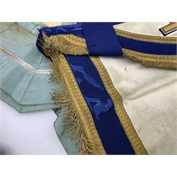 Two Masonic kid leather aprons, one with sash and cuffs, the other with sash, each marked 'Yorkshire North and East Ridings'; and three other unmarked Masonic aprons with sashes