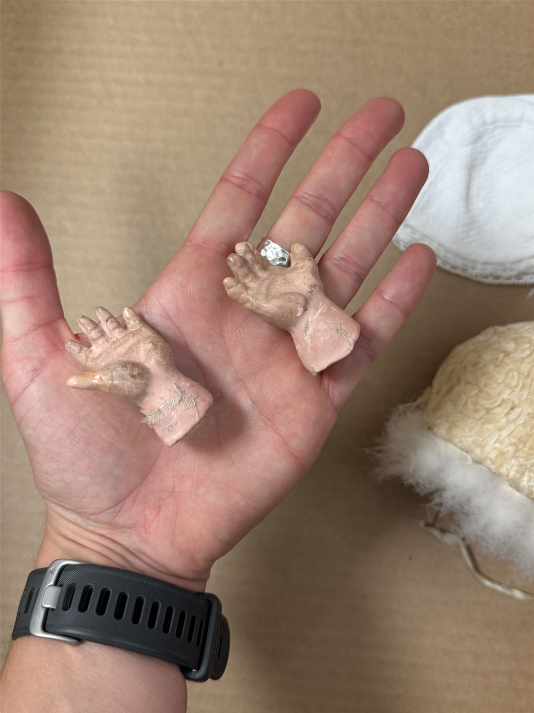 Two German bisque head dolls, to include a Franz Schmidt example with blue glass eyes and an Armand Marseille 590 example with applied hair, together with a Schoenau & Hoffmeister bisque doll's head, pair of doll's hands and a collection of clothing