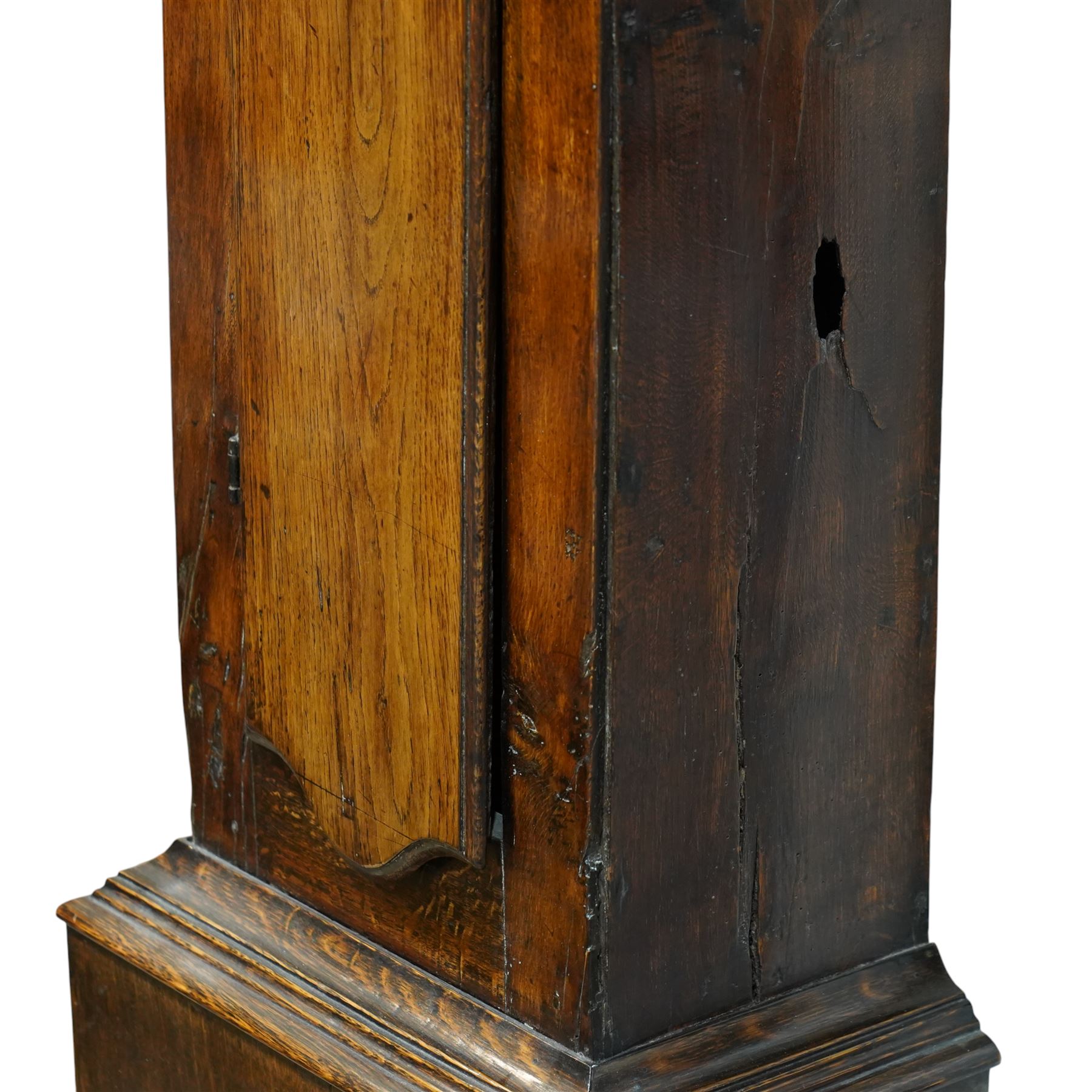 Jonas Barber of Winster (Westmoreland), provincial mid-18th century ash and oak cased 30-hour longcase clock, hood with a flat pediment, square hood door and attached pilasters, trunk with a full length shaped door on a square plinth with an applied skirt, brass dial with cast cherub spandrels, plain dial centre with date aperture and steel hands, silvered chapter ring engraved with Roman numerals, five minute Arabic's, quarter hour and minute tracks with half-hour markers, chain driven countwheel striking movement striking the hours on a bell. With weight and pendulum.
