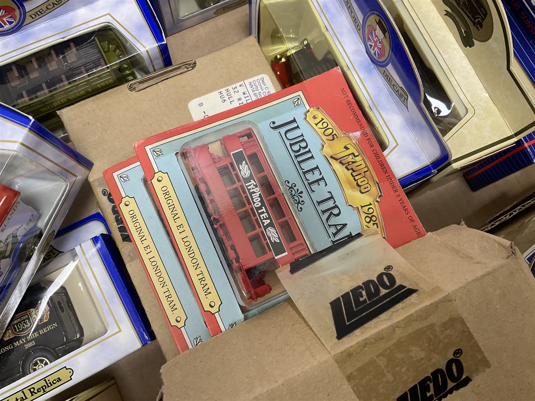 Collection of Tetley Tea collectibles to include sixteen 1:43 scale model cars from Lledo and Oxford Die-Cast with further Tetley Tea figures and tinned coaster set