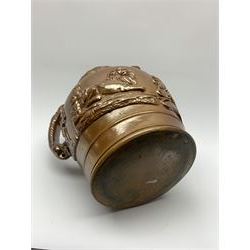 19th century salt glazed stoneware jug, with mask spout and greyhound modelled handle, the body decorated in relief with Royal Coat of Arms flanked by lions, the rim with the flowers of the union, roses, thistles and shamrocks, H26.5cm