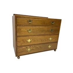 Mid-20th century oak chest, raised back, fitted with four graduating drawers, on castors