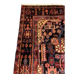 Persian Nahawand rug, overall floral design decorated with stylised flower head motifs, central medallion, repeating border 