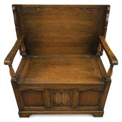 20th century oak monks bench with hinged box seat, with blind fretwork to the seat, panelled front and sides with linen fold panel in the centre