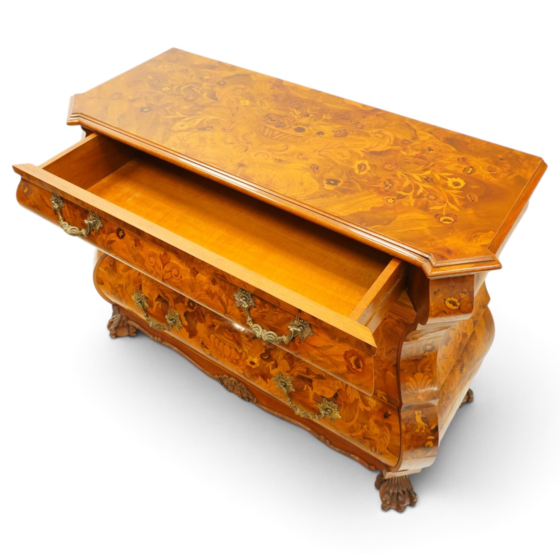 Colombo Mobili - Italian walnut and floral marquetry bombé commode chest, rectangular top with canted eared corners inlaid with urn motif and trailing scrolling foliage, fitted with three long graduating drawers with gilt metal handles, profusely inlaid with scrolling acanthus leaves interspersed with urns and cartouches, on large carved ball-and-claw feet