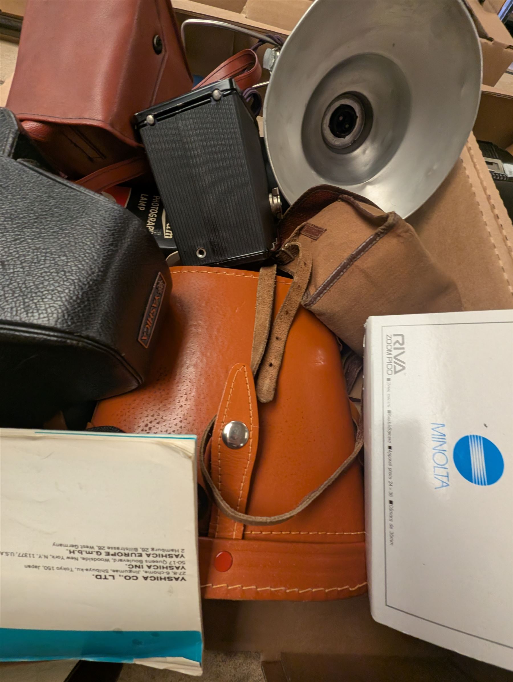 Collection of vintage cameras and photography equipment, including Minolta Riva Pico camera, Ensign Ful-VUe camera, Agfa Synchro Box, Yashica TL-Electro SLR Camera, pair of Ajaz 10x50 binoculars, etc