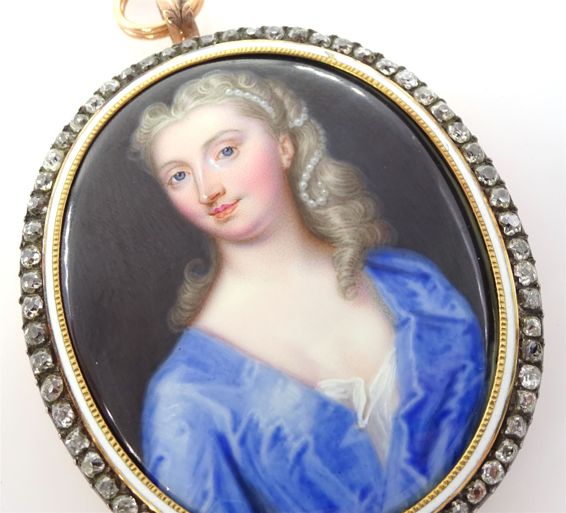 Christian Friedrich Zincke (German 1683-1767)
Portrait miniature upon enamel, circa 1750
Head and shoulder portrait of a young woman in blue gown, her hair adorned with pearls 
Within gilt frame, with old cut diamond border and white enamel inner border 
Oval 4.5cm x 3.5cm

Provenance
Purchased by the current vendor from Judy & Brian Harden Antiques September 98

Born in Dresden in 1683, Christian Friedrich Zincke travelled to London in 1706 to work at the studio of miniature painter and enamellist Charles Boit; later inheriting Boit's fashionable clientele. 
During his time in London Zincke is said to have dominated the market, training a number of well known English miniature painters including William Prewett, and also gaining Royal patronage aided by the endorsement of notable portrait artist Sir Godfrey Kneller.
Zincke worked extensively for the Royal Family, including George II and Frederick Prince of Wales, and is arguably the most successful enamel painter of the period in which he worked. 


