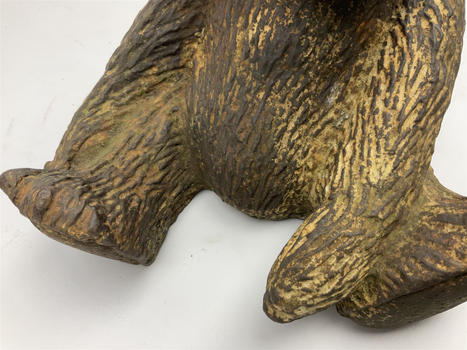 19th century cast iron door stop, modelled as a seated toy bear, with remnants of painted finish, H22.5cm