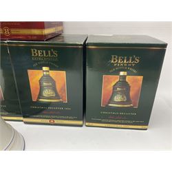 Dimple 15 Year Old Blended Scotch Whisky, together with nine Bells, scotch whisky, in Wade ceramic decanters, including Christmas 1991, 1998, 1996 etc, of various contents and proof 