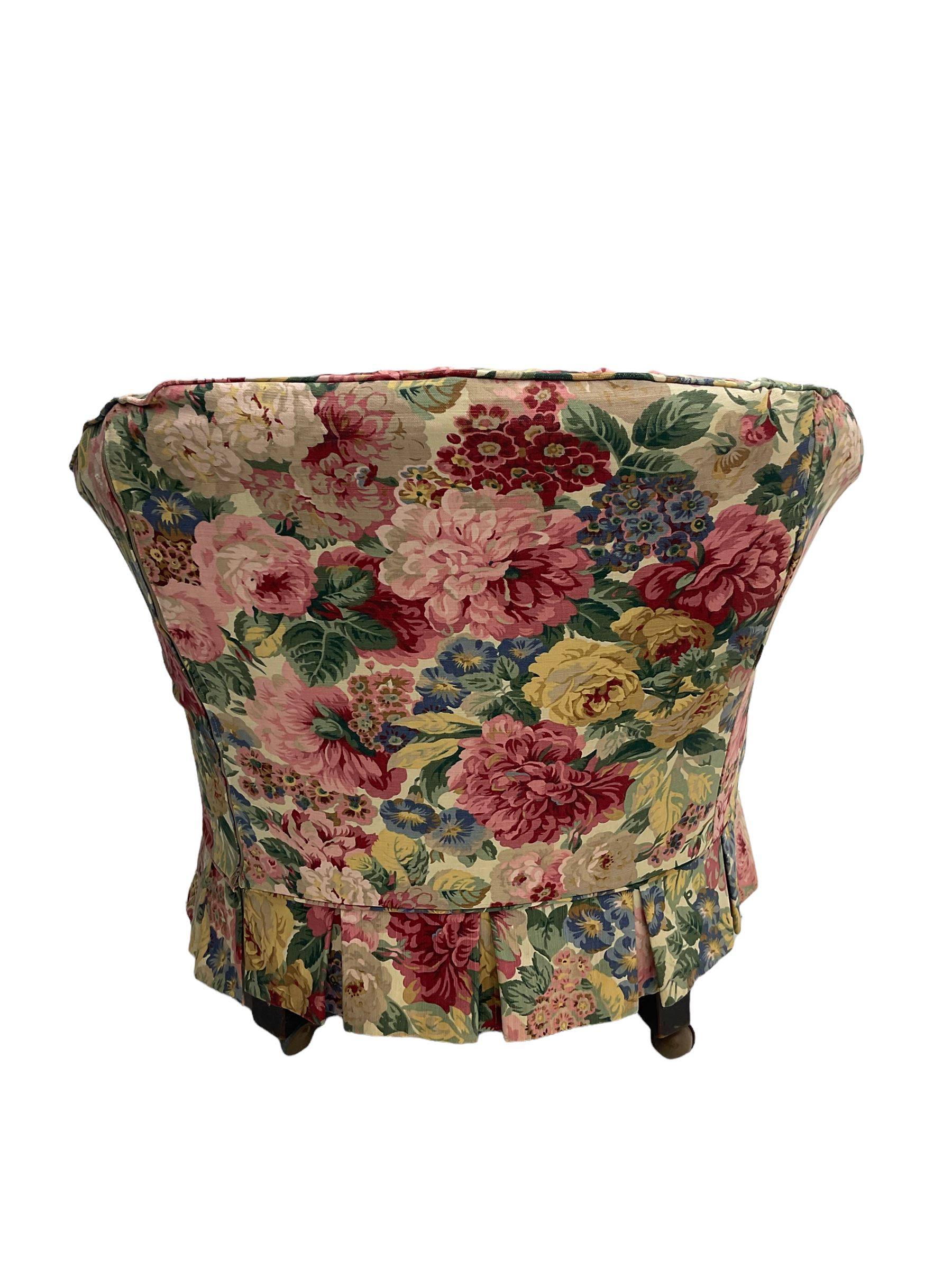 Victorian low tub shaped armchair, beech framed with compressed bun feet, loose floral fabric
