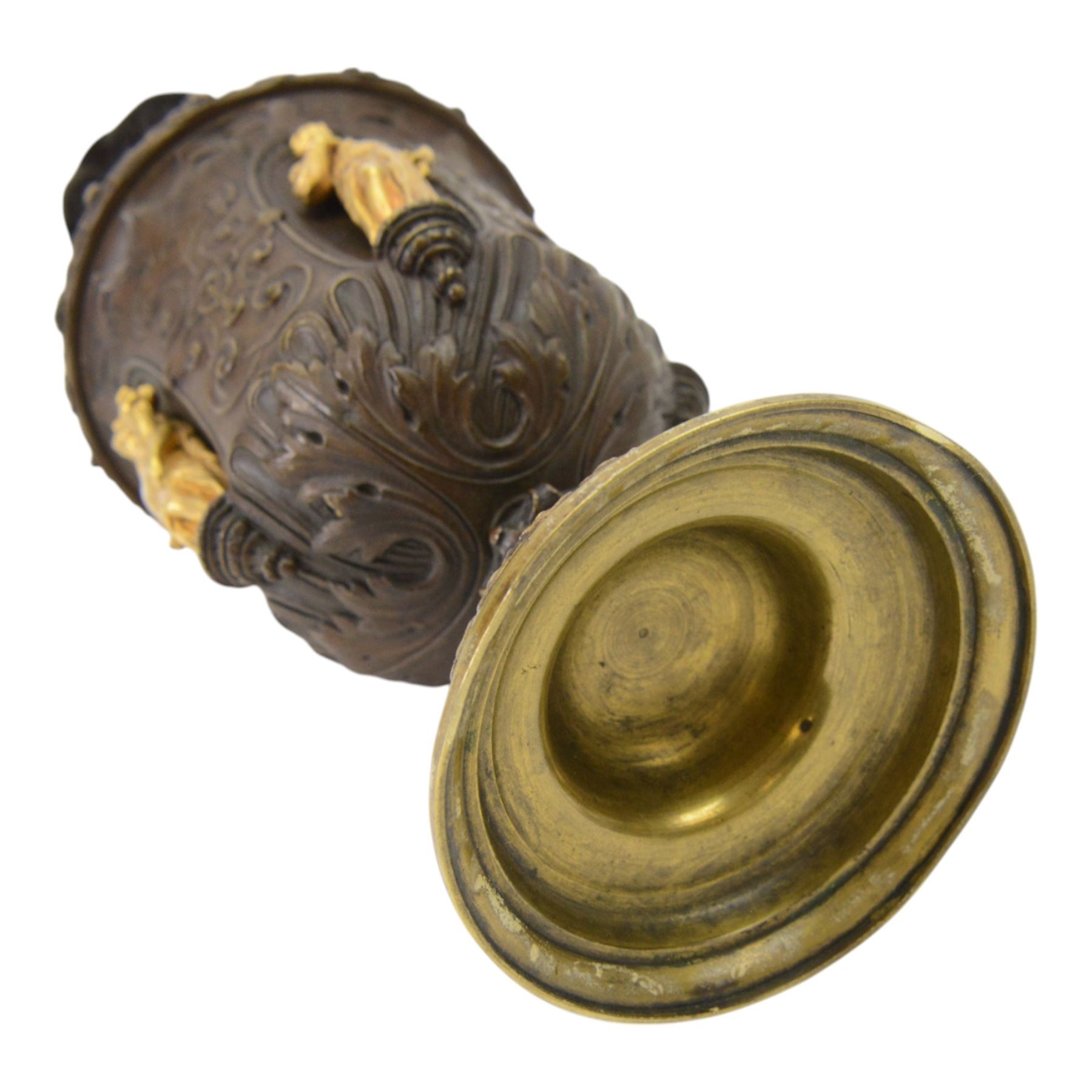 Pair of bronzed and gilt ewers in the Neo-Classical taste, each of typical form with figural detailed and mounted scroll handle surmounted by a winged figure, the bodies cast with scrolling strapwork, flower heads and acanthus leaves, and further detailed with applied gilt classical figures to oval recesses, upon a knopped stem and spreading circular foot with conforming cast detail, H28cm
