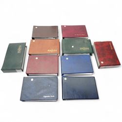 Eight folders and contents of full and part sets of cigarette cards