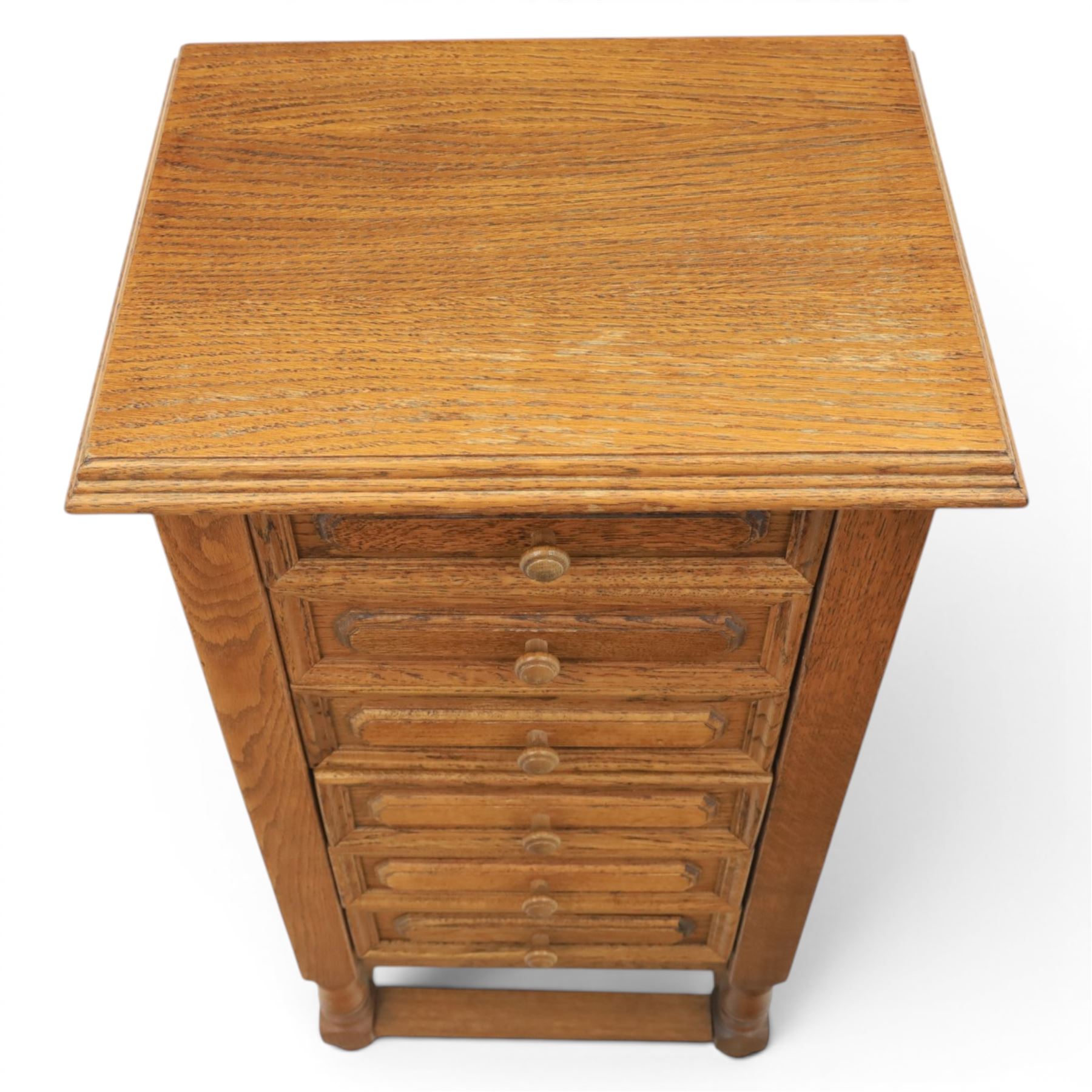 Early 20th century oak pedestal chest, with six drawers with moulded edges, raised on turned supports united by a stretcher 