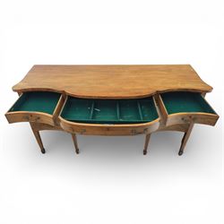 Early 20th century mahogany bow front sideboard, the shaped and moulded top above central kneehole recess with baize lined frieze drawer, flanked by twos drawers either side with the lower drawer double height, raised upon square tapering legs with spade feet