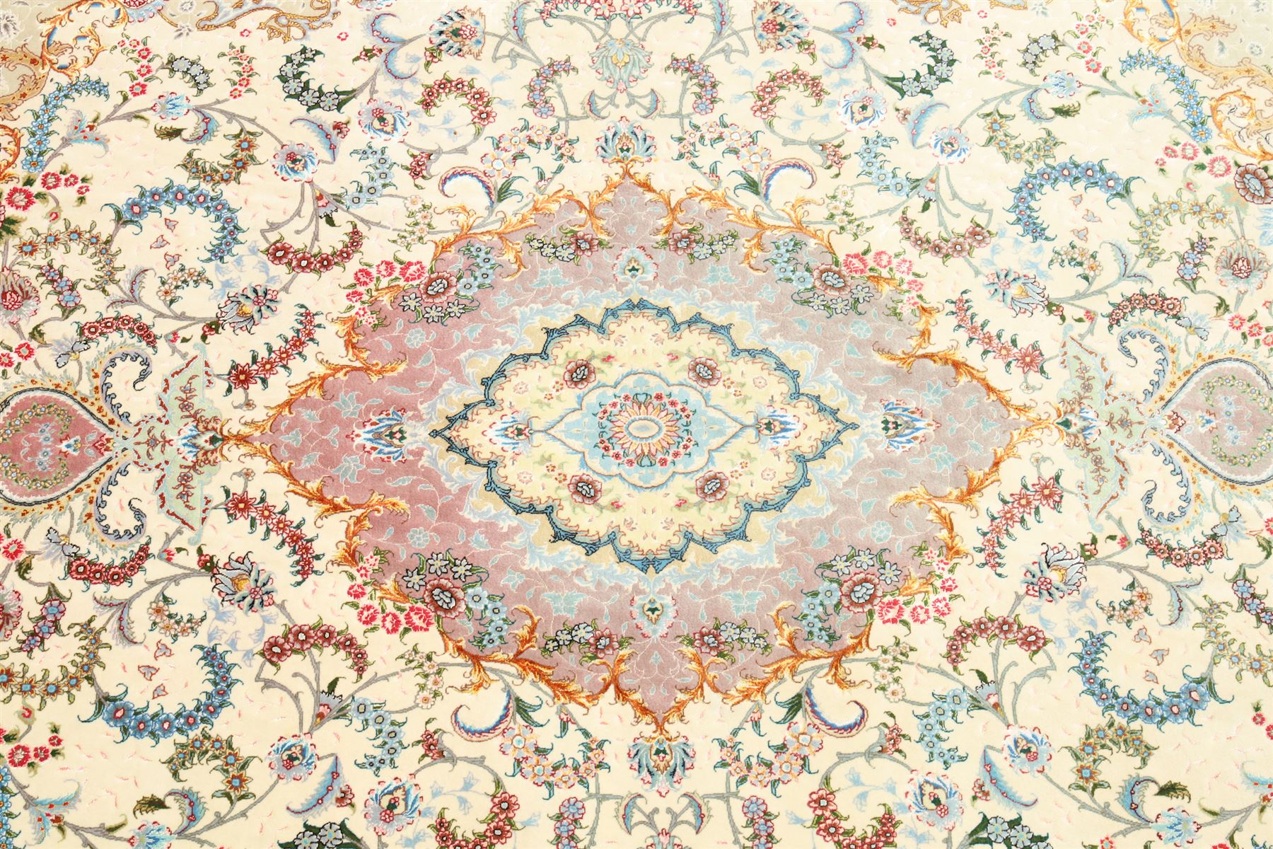 Fine Persian silk inlaid ivory and rose ground Tabriz rug, the busy field decorated with a central foliate pole medallion surrounded by scrolling foliage with trailing flowerheads and bouquets, the multiple guard lines filled with repeating scrolling palmettes and interlocking floral motifs