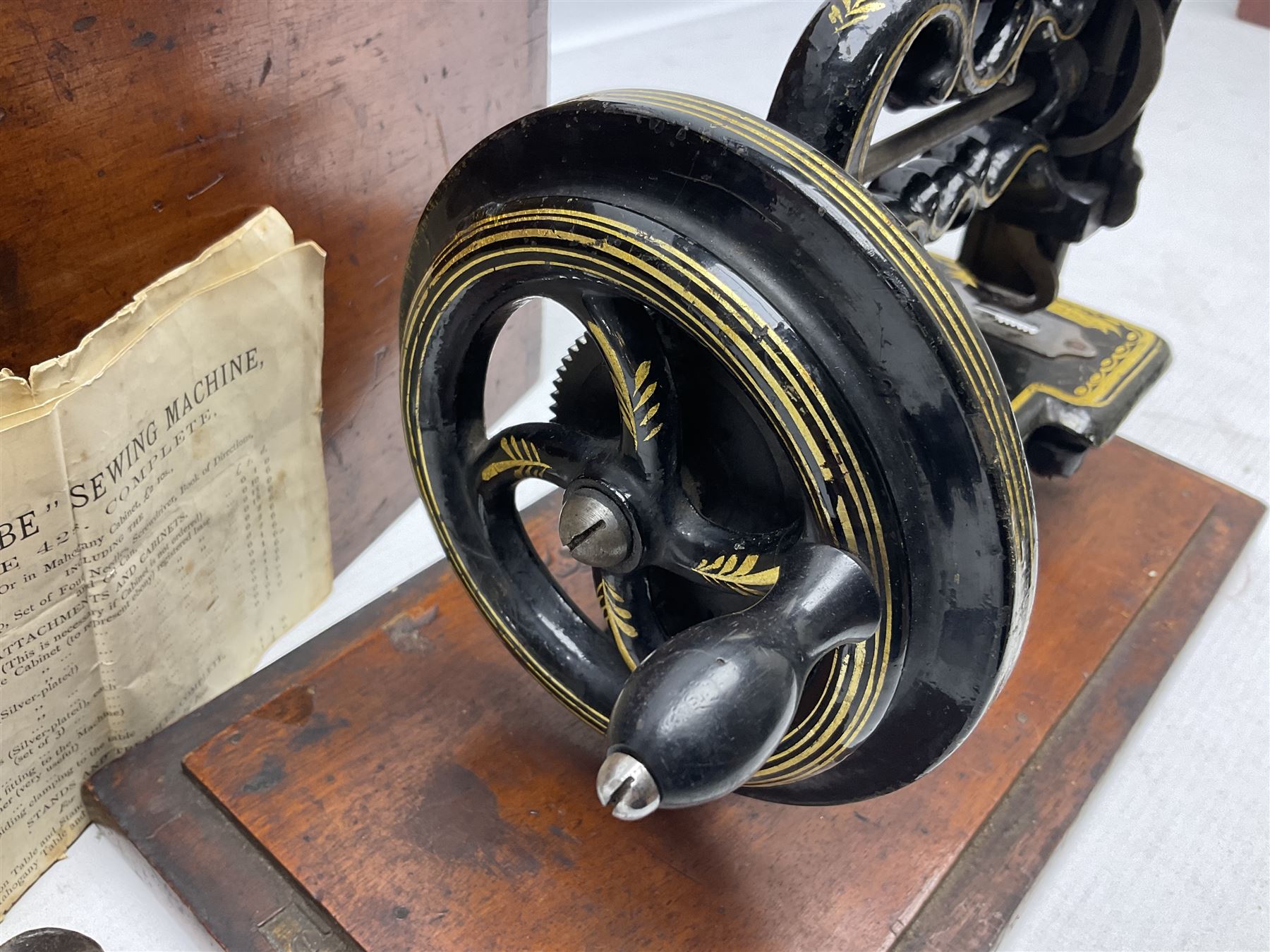 James G Weir 'The Globe' hand-cranked sewing machine, circa 1872, in black finish with gilt and flower painted decoration, the bed stamped Ja's G. Weir, 2 Carlisle Street, Soho Sq., London, with walnut locking carrying case and original manual, boxed H25cm 