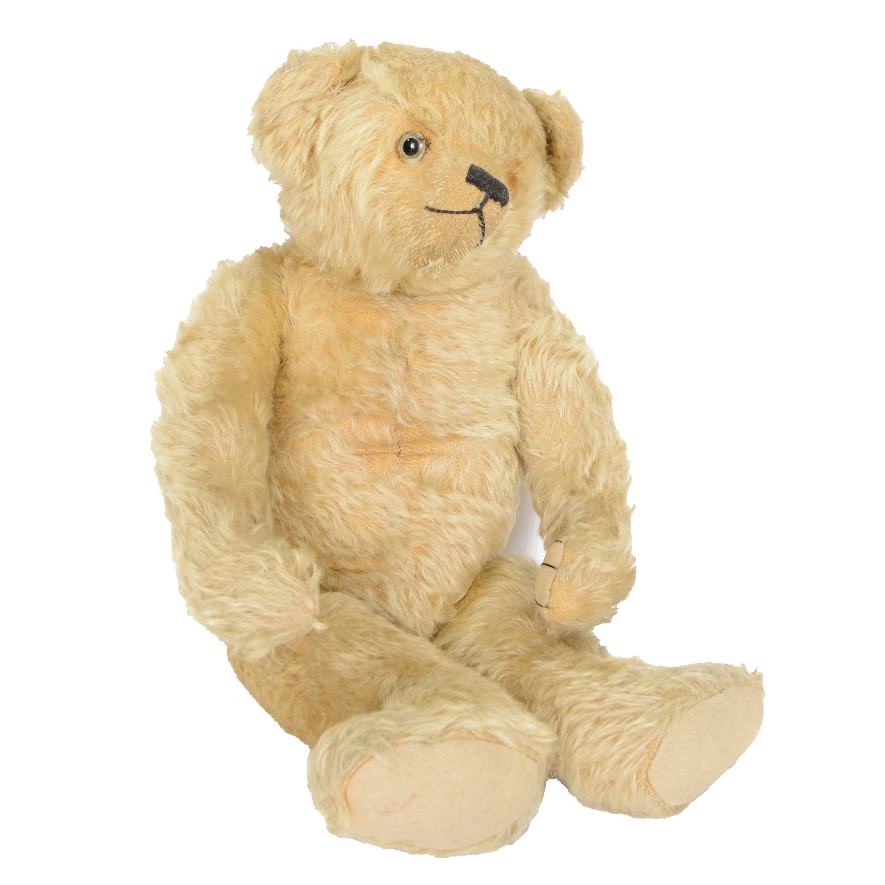 Early 20th century musical teddy bear, with golden mohair head and body, pronounced clipped muzzle, humped back, one eye, black/brown stitched nose, mouth and claws, swivel head and jointed limbs, containing pressure operated musical mechanism, L51cm

Notes by vendor repute: Previously owned by Dame Christian Howard of Castle Howard and given by her in the 1960s to the vendor who was the child of her house keeper.