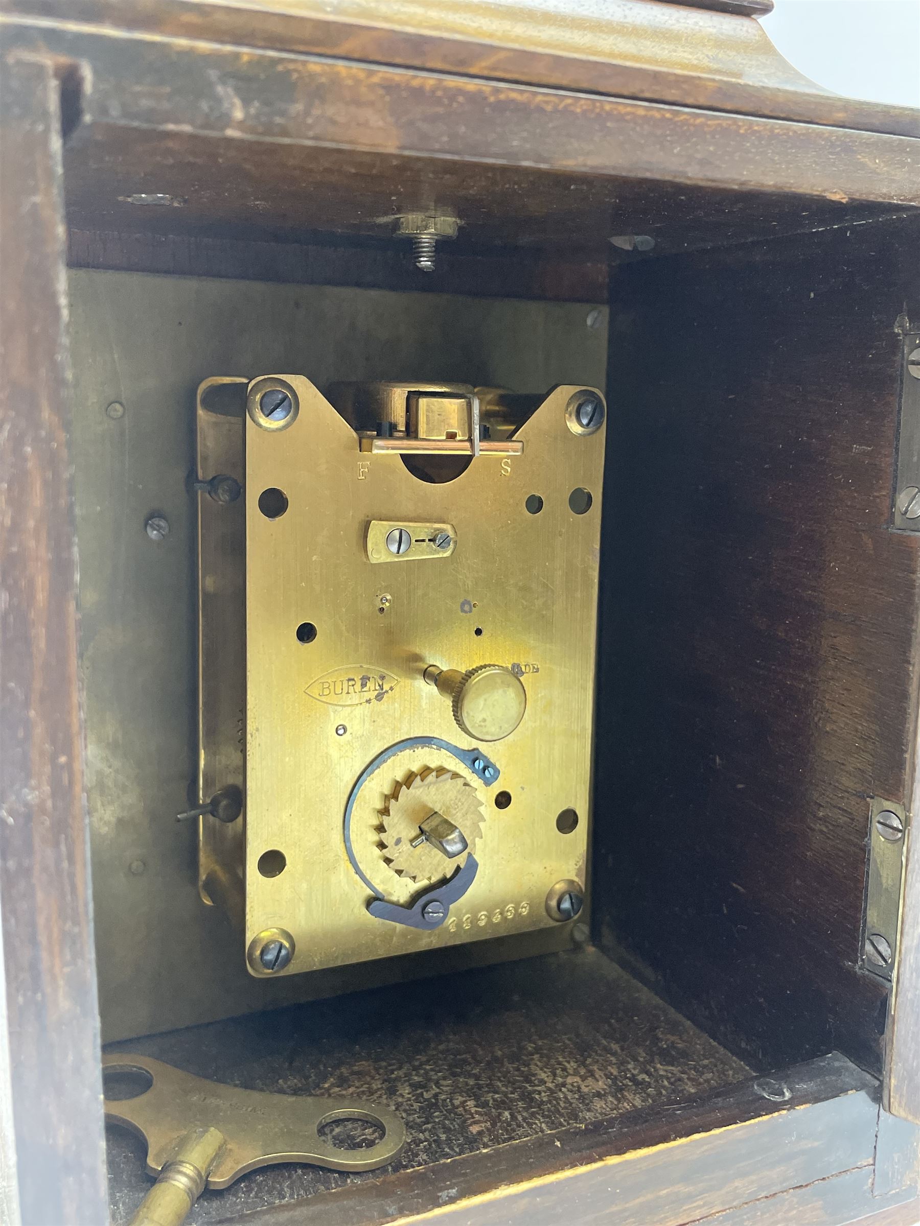 Small late 20th century walnut cased bracket clock. sarcophagus top with brass loop handle, brass dial with silvered Roman chapter ring and ornate spandrels, single train movement by 'Buren'