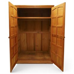 Beaverman - oak double wardrobe, enclosed by twin multi-panelled doors, Yorkshire Rose carved handles, the interior fitted with shelf and hanging rail, with signature carved beaver, by Colin Almack of Sutton, near Thirsk