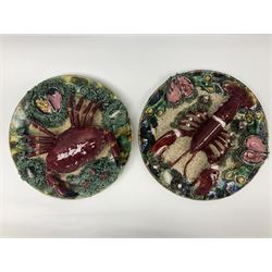 Two 20th Century Portuguese Palissy style Majolica wall plates, one depicting a crab, the other a lobster each to the centre modelled in relief surrounded by encrustations and shells, both with impress marks beneath, D34cm
