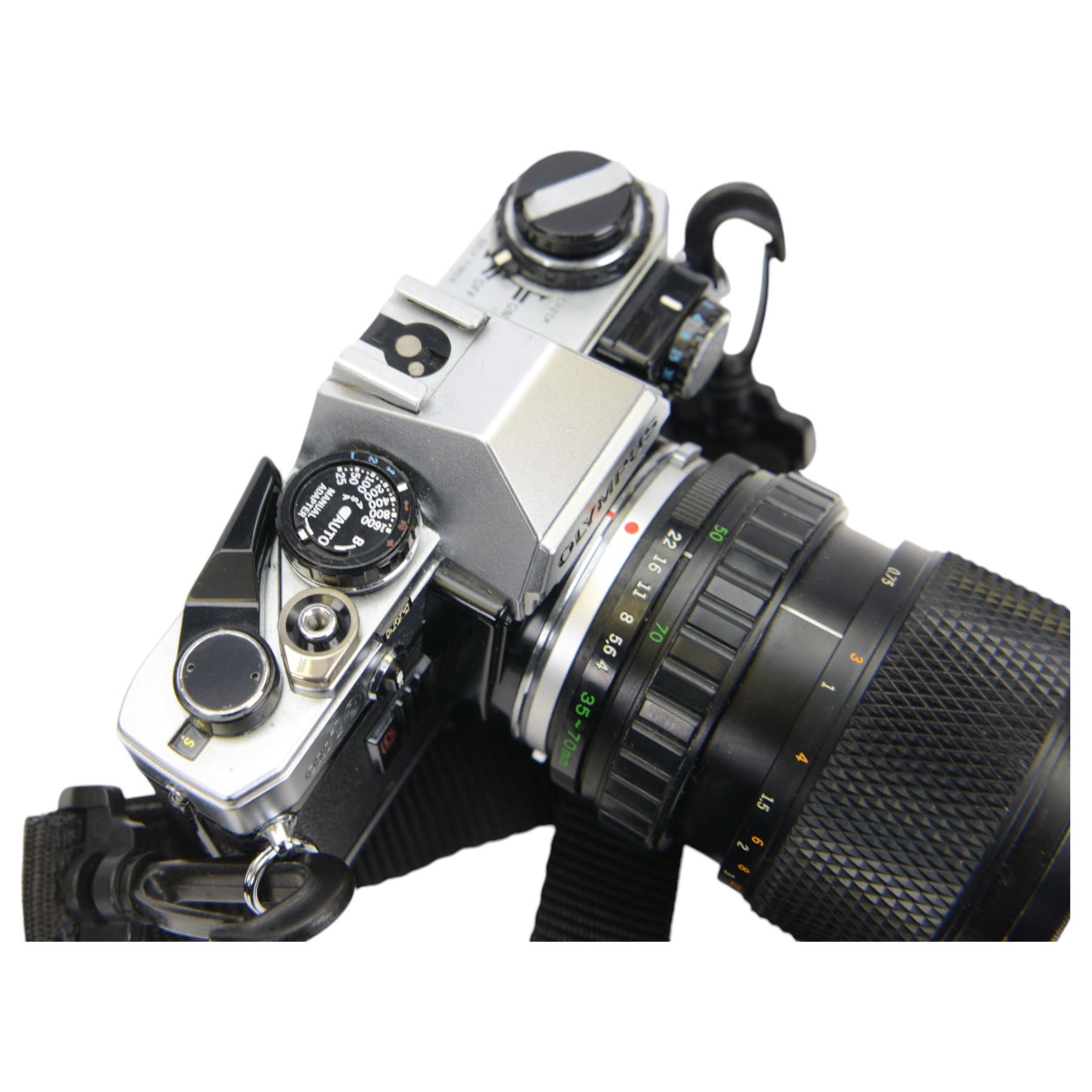 Olympus OM10 camera body serial no. 2279129, together with an Olympus OM-System S Zuiko Auto-Zoom 35-70mm 1:4 lens serial no. 283352, a Paragon 1:5.6 f=300mm 62 lens serial no. 12053, Hoya HMC Tele-Auto f-135mm 1:2.8 52 lens serial no. 638199, Tokina SD 70-210mm 1:4-5.6 52 serial no. 8844630, Olympus OM winder 2, Colly miniature/spy camera and other accessories in a Fotima carry case