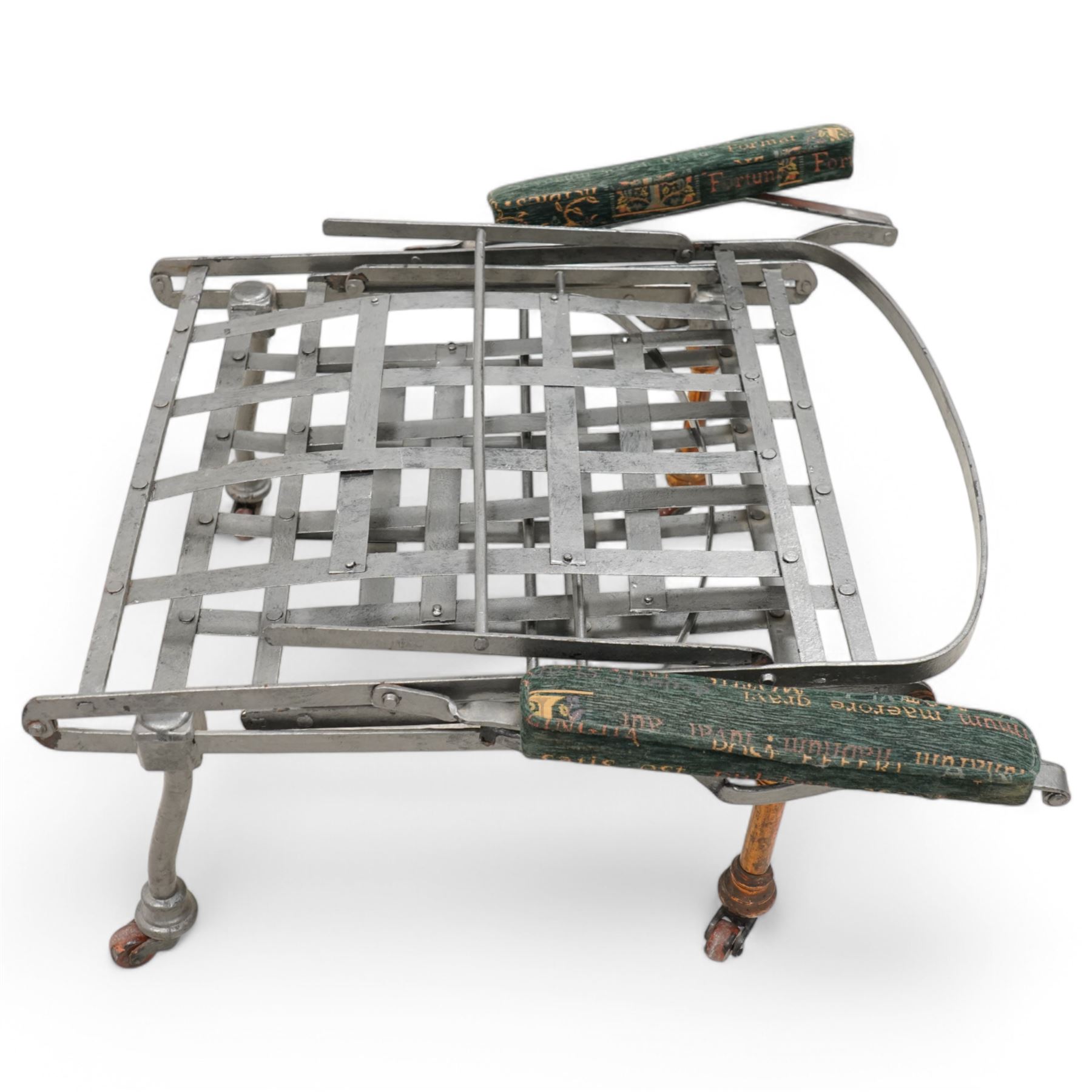 Victorian foldable day bed, button back padded arms, reupholstered in a green fabric with Latin script, turned feet with ceramic castors