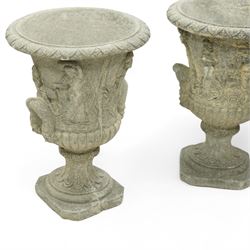 Late 20th century set of four composition stone campana urns, each with everted rim over acanthus and mask relief decoration, tapering to a fluted socle on square plinth base