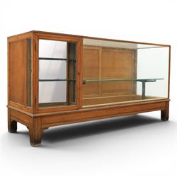 Early 20th century oak framed and glazed haberdashery shop counter with sliding doors and cupboards