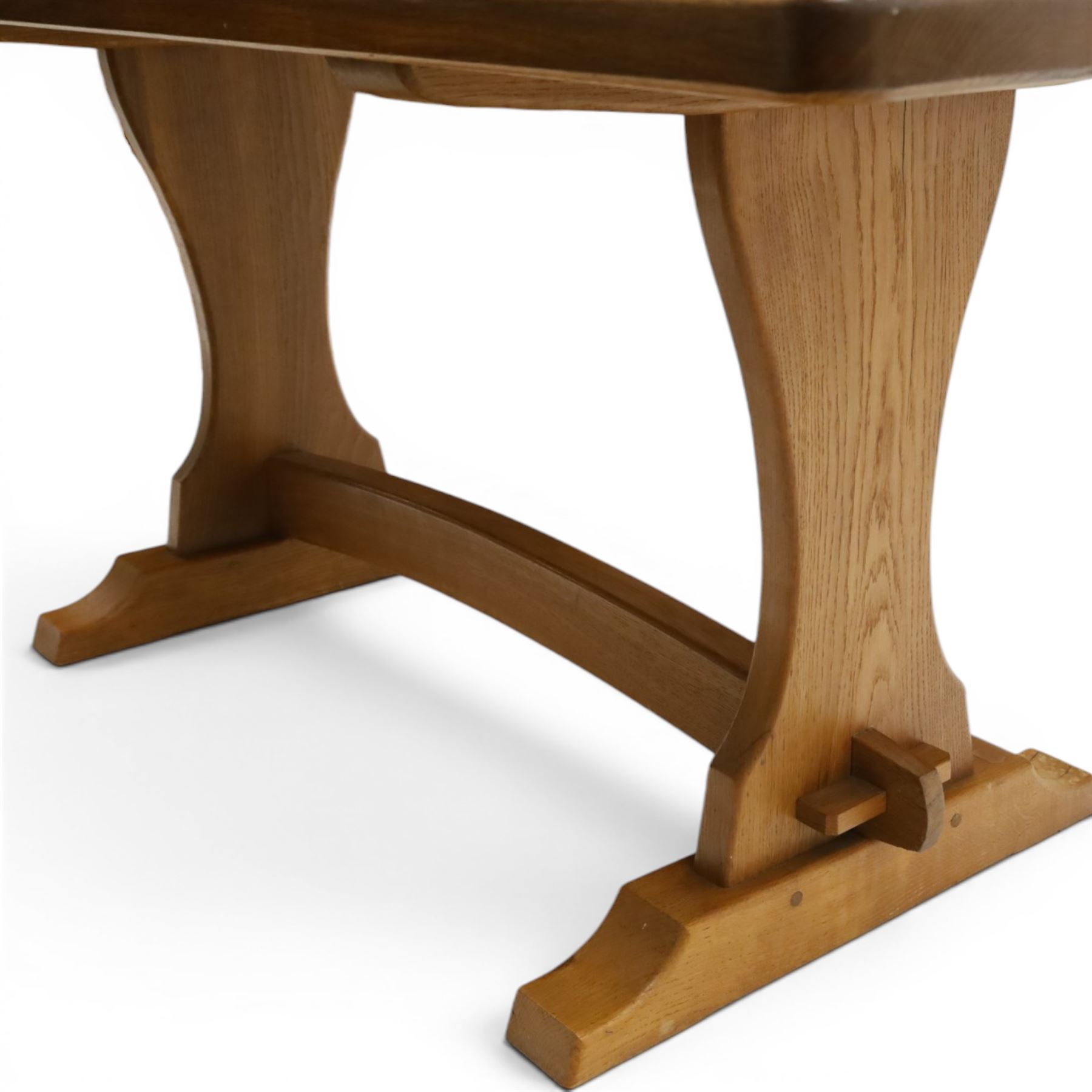 Knightman - oak refectory dining table, the rectangular adzed top raised on shaped trestle supports joined by central stretcher, with recessed carved knight trademark, by Horace Knight of Old Mill Furniture, Balk near Thirsk