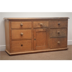  Early 20th century Pine dresser base, seven graduating drawers, single cupboard door, W135cm, H74cm, D47cm  