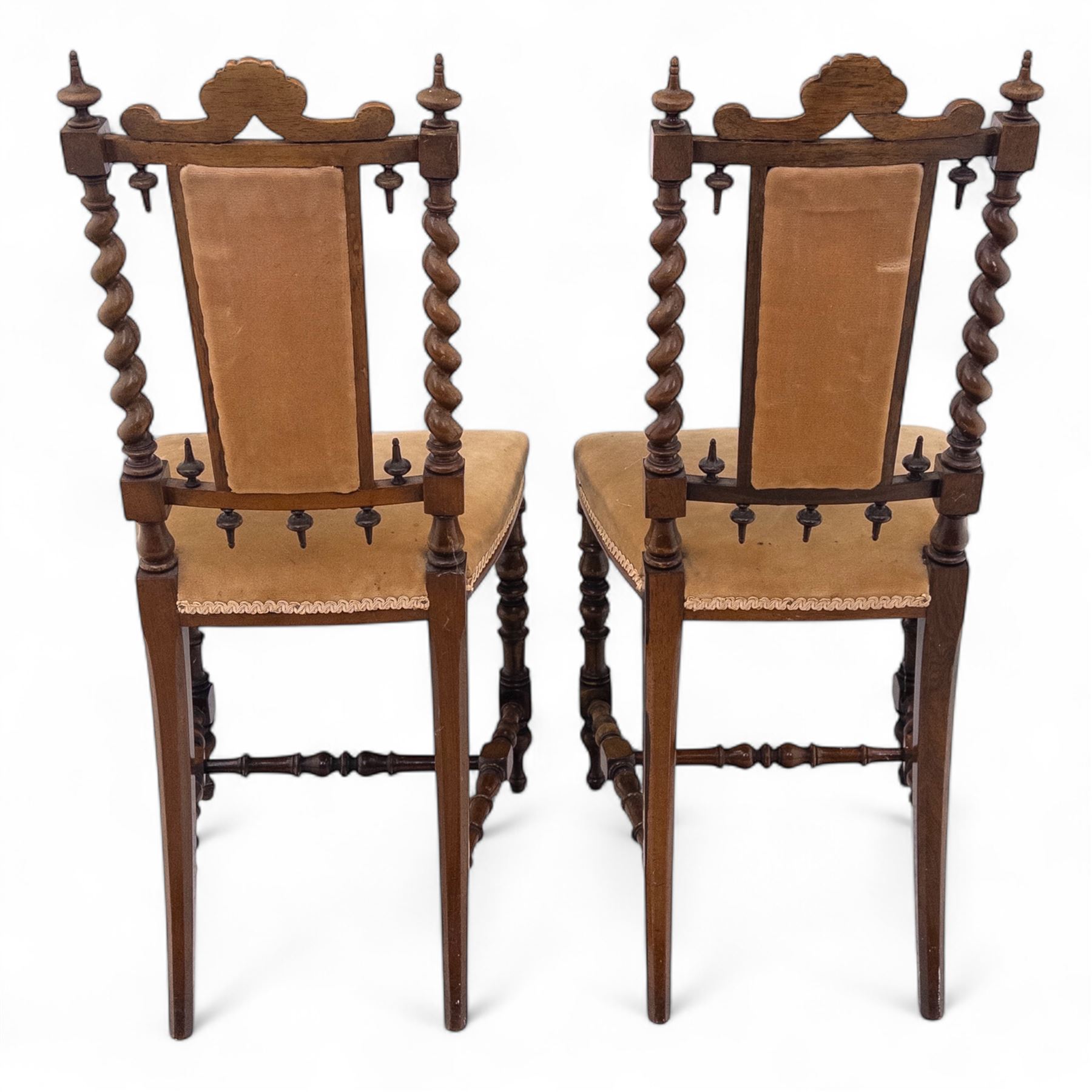 Pair of 19th century oak hall chairs, shield form backs with carved scroll cresting and finial uprights, upholstered in tan velvet, on turned and block supports joined by stretcher rails