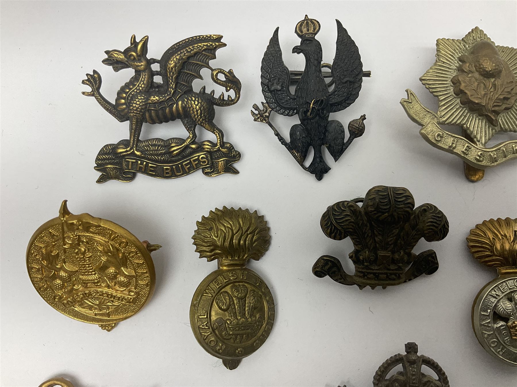 Two Edwardian hallmarked silver presentation fobs for military bugling competitions; and quantity of cap/glengarry and other badges, sweetheart brooches etc