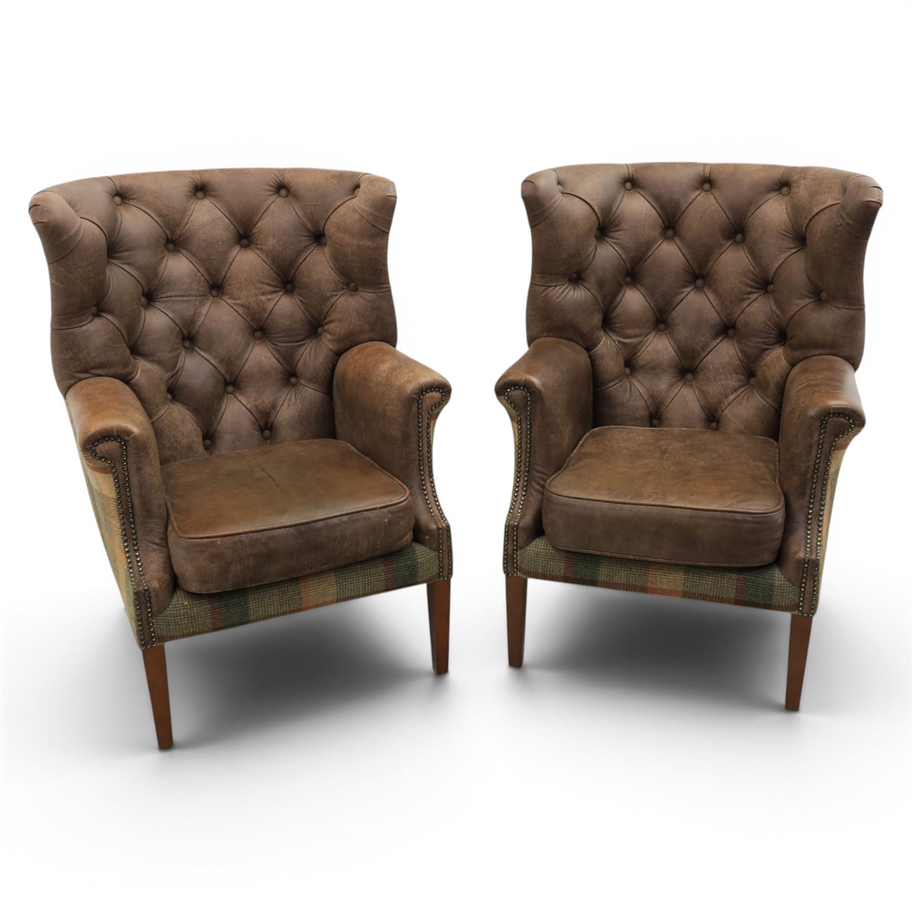 Pair of Georgian design wingback armchairs upholstered in brown leather and tartan tweed fabric, button back and scrolled arms with brass studded trim, square tapered supports