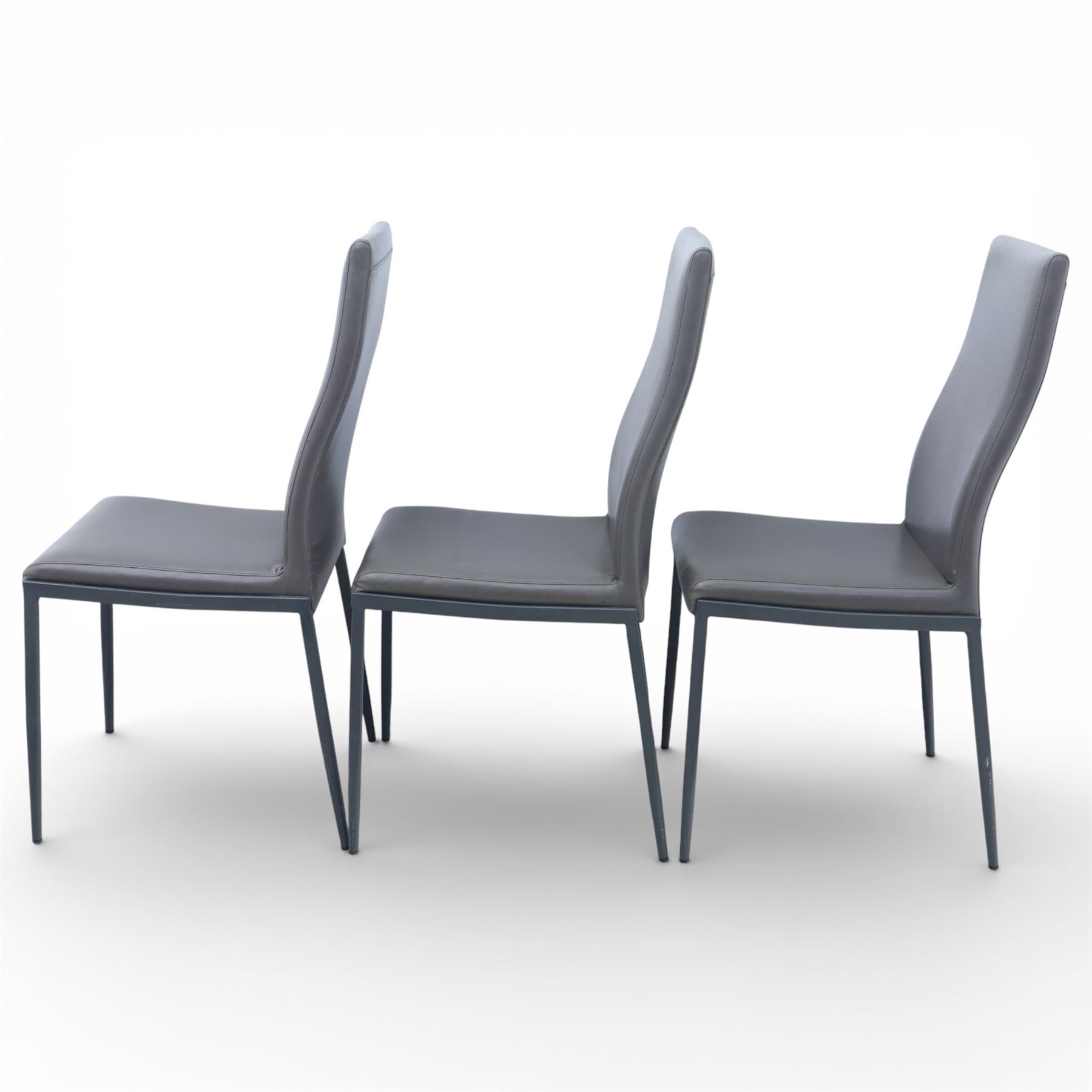 Modern composite marble effect dining table, rectangular top with simulated veining supported on a block pedestal base, accompanied by six matching dining chairs with padded seats and backs in grey upholstery on slim metal legs