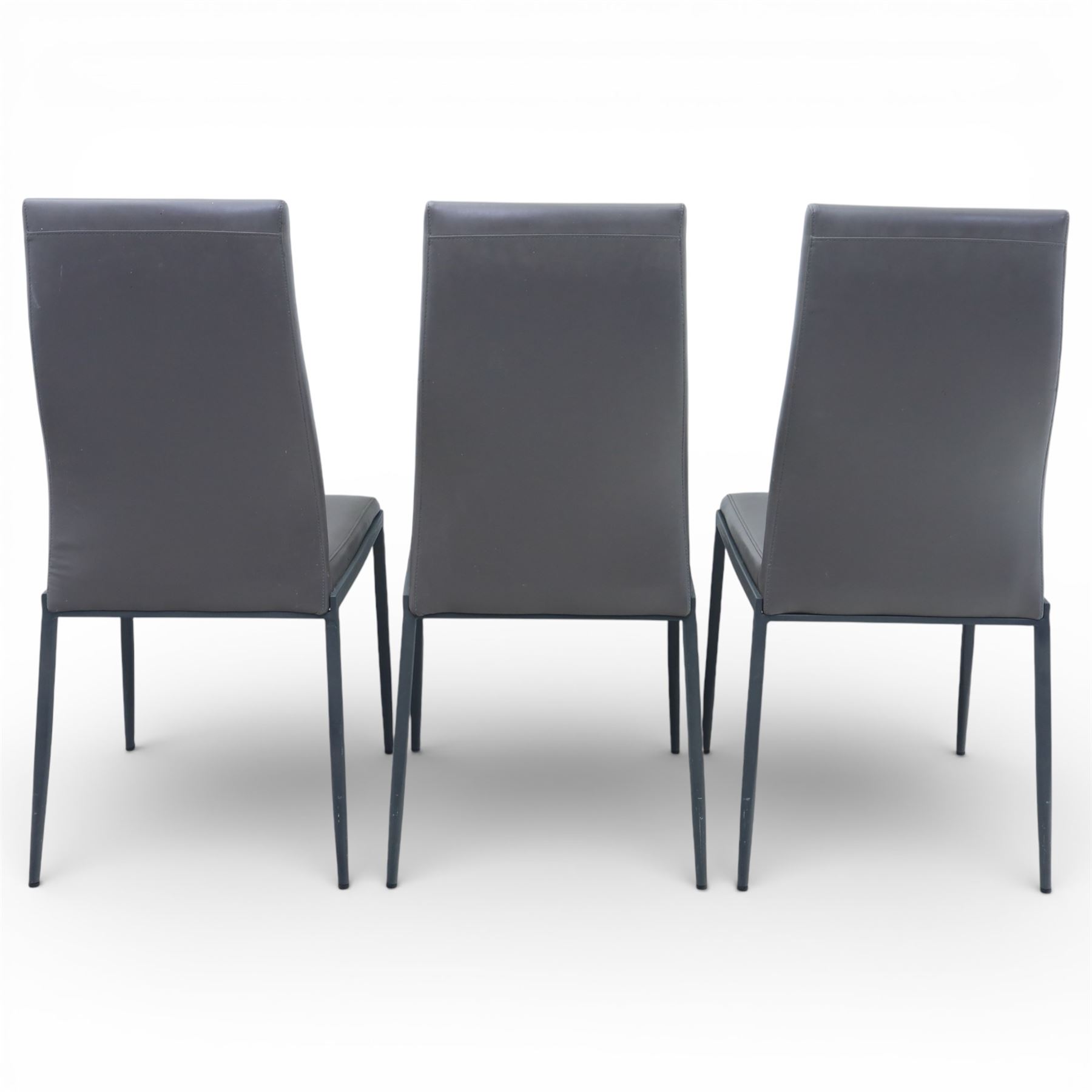 Modern composite marble effect dining table, rectangular top with simulated veining supported on a block pedestal base, accompanied by six matching dining chairs with padded seats and backs in grey upholstery on slim metal legs